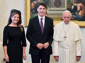 Pope Francis looking miserable next to Justin and Sophie Trudeau.