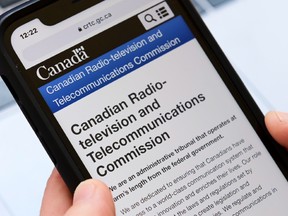 The CRTC website is seen on a cellphone.