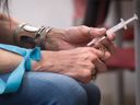 An addict injects hydromorphone, one of the drugs available for free through B.C.'s safer supply programs.