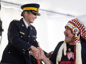 Prince Albert Grand Council Grand Chief Brian Hadlotte shakes hands with RCMP Assistant Commissioner Rhonda Blackmore.