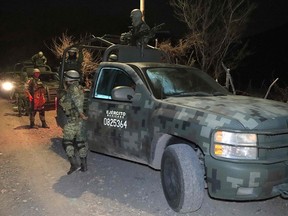 Soldiers guard the area after an explosives attack in Jalisco State, Mexico.