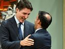 Prime Minister Justin Trudeau embraces Minister of Justice and Attorney General of Canada Arif Virani during a cabinet swearing-in ceremony at Rideau Hall in Ottawa, Wednesday, July 26, 2023.