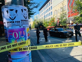 Police investigate a serious assault on Granville Street in downtown Vancouver on Aug. 4, 2023.