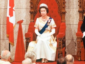 Queen Elizabeth II officially opens the session of Parliament in the Senate chamber in Ottawa on October 18, 1977.