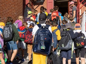 Students arrive for the first day of school at École primaire Sainte-Cécile in Montreal’s Villeray district on Aug. 28, 2023.