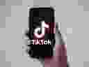 FILE: In this file photo taken on January 21, 2021 in Nantes, western France, a man shows a smartphone with the logo of TikTok. 