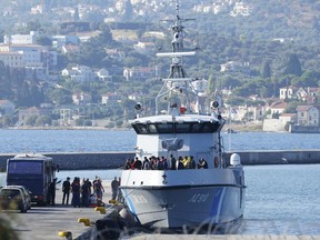 Migrants disembark from a Greek coast vessel after a rescue operation, at the port of Mytilene, on the northeastern Aegean Sea island of Lesbos, Greece, Monday, Aug. 28, 2023. Greek authorities say four people died and 18 were rescued Monday after a boat carrying migrants apparently sank northeast of the Greek island of Lesbos, which lies near the Turkish coast.