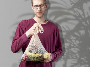 Man holding a reusable bag.