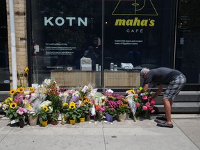 Flowers are shown at a makeshift memorial at the place where a mother of two, Karolina Huebner-Makurat, was killed by a stray bullet in Toronto, Monday, July 10, 2023.