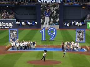 Former Toronto Blue Jays player Jose Bautista throws the ceremonial first pitch after his name was unveiled on the Jays' Level of Excellence, ahead of their MLB interleague baseball game against the Chicago Cubs, in Toronto, Saturday, Aug. 12, 2023.