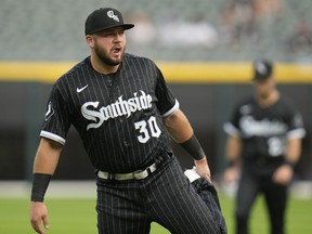 Chicago White Sox's Jake Burger warms up before a baseball game against the Cleveland Guardians, Friday, July 28, 2023, in Chicago.