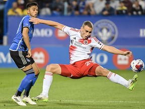 CF Montreal's Mathieu Choiniere, left, challenges New England Revolution's Noel Buck during first half MLS soccer action in Montreal, Saturday, August 26, 2023.
