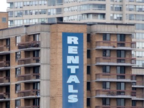 A 'rental' sign hangs on the side of an apartment building in Ottawa.