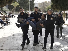 FILE - Israeli police detain a Palestinian in the Al-Aqsa Mosque compound following a raid of the site in the Old City of Jerusalem during the Muslim holy month of Ramadan, Wednesday, April 5, 2023. Israel is holding 1,201 detainees -- nearly all of them Palestinians --without charge or trial, the highest number in over three decades, an Israeli human rights group said Tuesday, Aug. 1, 2023.