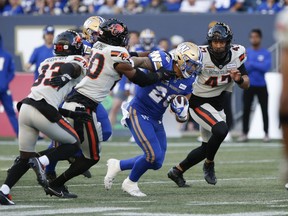 Winnipeg Blue Bombers' Brady Oliveira (20) runs for the first down against the B.C. Lions during first half CFL action in Winnipeg Thursday, June 22, 2023. Brady Oliveira wants to take a bite out of the "Doughnut Boys." The CFL's leading rusher and his Winnipeg Blue Bombers host the B.C. Lions and their top-ranked defence Thursday at IG Field.