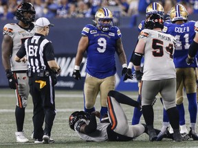Winnipeg Blue Bombers' Ricky Walker (9) stands over B.C. Lions quarterback Dominique Davis (8) after he was sacked during second half CFL action in Winnipeg Thursday, August 3, 2023. For two seasons, Walker saw spot duty with the Blue Bombers. But while the six-foot-two, 287-pound defensive tackle never doubted he could be a CFL starter, he understood the need to bide his time.