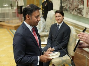 Justice Minister and Attorney General of Canada Arif Virani takes the oath of office as Prime Minister Justin Trudeau watches.