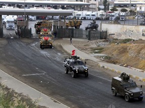 FILE - Turkish Army vehicles are driven away on a convoy at the Habur/Ibrahim Khalil border crossing with Iraq, near Silopi, southeastern Turkey, Tuesday, Oct. 31, 2017. At least 6 Turkish soldiers killed in attacks by Kurdish fighters in northern Iraq, Ankara says on Thursday, Aug, 10, 2023. (DHA-Depo Photos via AP, File)