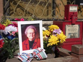 A makeshift shrine is set up in front of the Marion County Record in Marion, Kan. on Saturday, Aug. 19, 2023 with a picture of the newspaper's co-owner Joan Meyer and flowers.