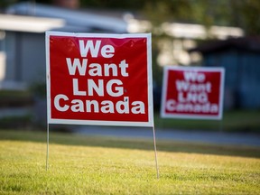 Signs reading "We Want LNG Canada" stand on a lawn in the residential area of Kitimat, British Columbia, Canada, on Monday, Aug. 22, 2016.