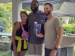From left to right, Christina Hayes, former NFL football player Michael Oher, whose story became the inspiration for the Oscar-nominated movie "The Blind Side," and Sam Noel pose for a photo at Oher's book-signing at The Ivy Bookshop in Baltimore, Monday, Aug. 21, 2023. Last week, Oher sued Sean and Leah Anne Tuohy to lift his conservatorship with them.