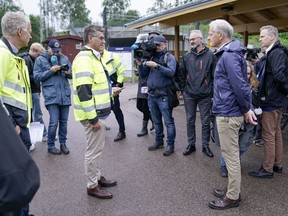 Norway's Prime Minister Jonas Gahr Store and Norway's Transport Minister Jon-Ivar Nygard attend the media at the site damaged by flood at Leirsund station in Leirsund, Norway, Wednesday Aug. 9, 2023. Landslides were reported overnight across mountainous southern Norway with police on Wednesday saying more than 600 people have been evacuated in the region north of Oslo. For days, the storm battered parts of Scandinavia and the Baltics, leading to rivers and streams going over their banks.