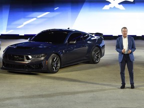 FILE - Bill Ford, executive chairman of Ford Motor Company, introduces one of the models of the 2024 Ford Mustang, the performance vehicle Dark Horse, at the North American International Auto Show, Wednesday, Sept. 14, 2022, in Detroit. New versions of the Mustang muscle car will begin shipping next week and more than two thirds of the orders include the big, 5-liter V-8 engine, Ford said Friday, Aug. 11, 2023.