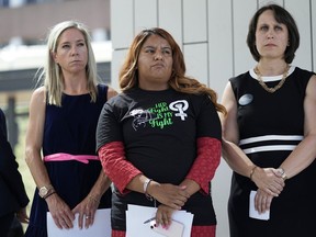 FILE - Amanda Zurawski, who developed sepsis and nearly died after being refused an abortion when her water broke at 18 weeks, left, and Samantha Casiano, who was forced to carry a nonviable pregnancy to term and give birth to a baby who died four hours after birth, center, stand with their attorney Molly Duane outside the Travis County Courthouse, Wednesday, July 19, 2023, in Austin, Texas. A Texas judge ruled Friday, Aug. 4, 2023, the state's abortion ban has proven too restrictive for women with serious pregnancy complications and must allow exceptions without doctors fearing the threat of criminal charges. The challenge is believed to be the first in the U.S. brought by women who have been denied abortions since the Supreme Court last year overturned Roe v. Wade, which for nearly 50 years had affirmed the constitutional right to an abortion.