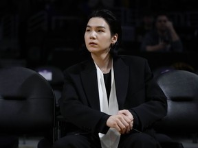 FILE - BTS member Suga attends an NBA basketball game between the Los Angeles Lakers and the Dallas Mavericks on Jan. 12, 2023, in Los Angeles. Suga has become the third member of BTS to begin South Korea's compulsory military service. BTS' label, Big Hit Music, said in a statement on Monday, Aug. 7, 2023, that Suga "has initiated the military enlistment process by applying for the termination of his enlistment postponement."