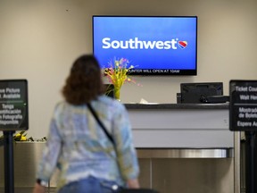 File - A Southwest Airlines passenger arrives to check-in at the Des Moines International Airport, April 18, 2023, in Des Moines, Iowa. A federal judge has set off a debate among legal scholars by ordering lawyers for Southwest Airlines to undergo "religious-liberty training" by a conservative Christian legal group.