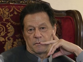 FILE - Pakistan's former prime minister Imran Khan listens to a member of media during talk with reporters regarding the current political situation and the ongoing cases against him at his residence, in Lahore, Pakistan, Thursday, Aug. 3, 2023. A top Pakistani court Wednesday, Aug. 9, 2023, said it wanted to hear from the government before deciding over former Prime Minister Imran Khan's appeal against his imprisonment on corruption charges.