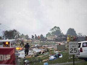 Police and emergency services search the wreckage of the three houses that exploded near Rustic Ridge Drive and Brookside Drive in Plum, Pa., on Saturday, Aug. 12, 2023.