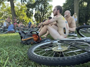 Riders wait for the start of the Philly Naked Bike Ride in Philadelphia, Saturday, Aug. 26, 2023.