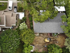 Authorities continue to work at the home of suspect Rex Heuermann, who has been charged with killing at least three women in the long-unsolved slayings known as the Gilgo Beach killings, bottom right, in Massapequa Park, N.Y., Monday, July 24, 2023.