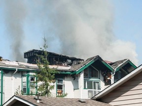 Surrey firefighters work to extinguish a stubborn blaze that engulfed a three-storey apartment building at 13911 70th Ave. in the city on Aug. 4, 2021.