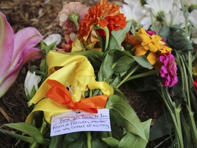 Flowers are seen piled up in front of Caudill Labs, Tuesday, Aug. 29, 2023 on the UNC-Chapel Hill campus, where a graduate student fatally shot his faculty advisor, Zijie Yan, this week in Chapel Hill, N.C.
