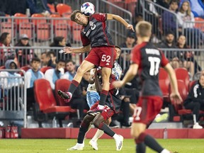 Toronto FC midfielder Alonso Coello (52) heads the ball during first half MLS soccer action against the Philadelphia Union in Toronto, on Wednesday, Aug. 30, 2023.