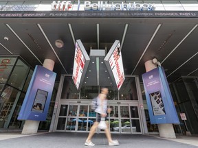 A person walks past the Toronto International Film Festival (TIFF) Bell Lightbox in the Entertainment District of Toronto on Thursday, Aug. 17, 2023.
