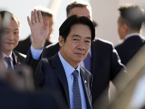 FILE - Taiwan's Vice President William Lai Ching-te waves after landing at Silvio Pettirossi airport in Luque, Paraguay, on Aug. 14, 2023. The Chinese military launched drills around Taiwan on Saturday, Aug. 19 as a "stern warning" over what it called collusion between "separatists and foreign forces," its defense ministry said, days after the island's vice president stopped over in the United States.