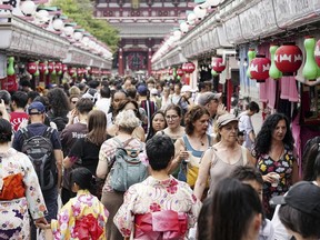 The Nakamise shopping street to Sensoji temple is crowded with visitors and foreign tourists in the Asakusa district in Tokyo Japan, on July 19, 2023. Japan's economic growth jumped at an annual pace of 6% in the April-June period, marking the third straight quarter of growth as exports and inbound tourism recovered.(Kyodo News via AP)