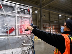 A shipment of Moderna COVID-19 vaccine doses is scanned at Toronto Pearson Airport.