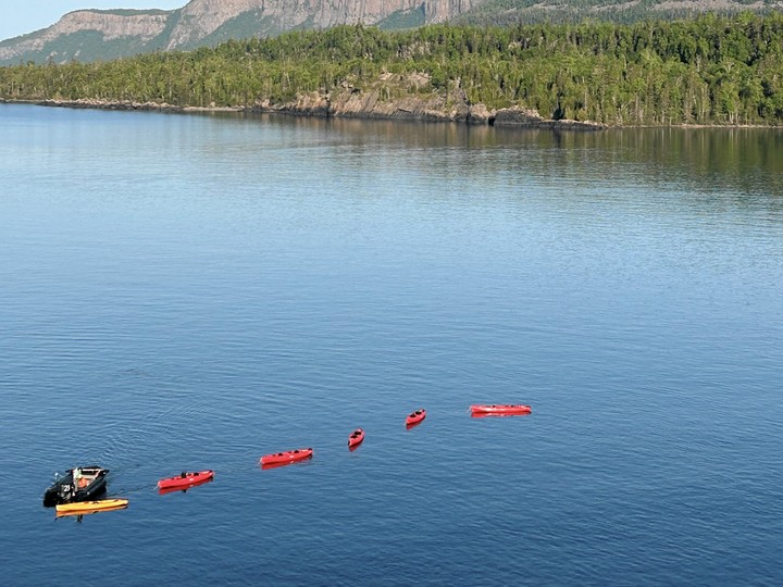  A member of the expedition team aboard Viking Octantis pulls a string of kayaks on Lake Superior.