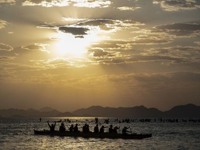 People canoe off Copacabana beach in Rio de Janeiro, Brazil at sunrise, Thursday, Aug. 24, 2023. Brazil is facing a heat wave during the southern hemisphere's winter.