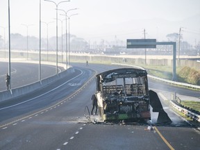 A burnt out bus stands on a freeway on the outskirts of Cape Town, South Africa, Tuesday, Aug. 7, 2023. Two people were fatally shot on a fifth day of violent protests in sparked by a dispute last week between minibus taxi drivers and authorities. The unrest on the outskirts of South Africa's second-largest city follows an announcement last Thursday of a weeklong strike by minubus taxi drivers angered at what they call heavy-handed tactics by police and city authorities. (AP Photo)