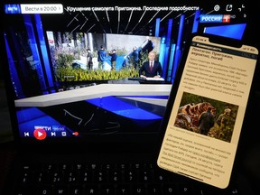 Website of the Russian newspaper Kommersant and TV channel Rossiya 1 showing news that Wagner Group mercenary leader Yevgeny Prigozhin had reportedly been killed in a plane crash are displayed on phone and computer screens in St. Petersburg, Russia, Thursday, Aug. 24, 2023. World media speculates on Prigozhin's presumed death, as Russian state media shies away.