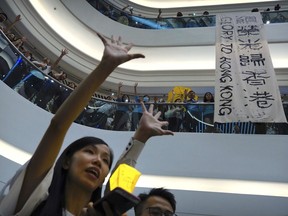 FILE - Demonstrators sing a theme song written by protestors "Glory to Hong Kong" at the Times Square shopping mall in Hong Kong, Thursday, Sept. 12, 2019. The Hong Kong government was given the green light on Wednesday, Aug. 23, 2023 to appeal a court's refusal to ban a protest song, after government lawyers cited national security concerns.