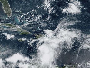 In this Tuesday, Aug. 22, 2023, 9:40am ET satellite image provided by the National Oceanic and Atmospheric Administration, Tropical Storm Franklin approaches Hispaniola island. Authorities in the Dominican Republic prepared to shut down much of the country Tuesday as the storm took aim at the island it shares with Haiti. (NOAA via AP)