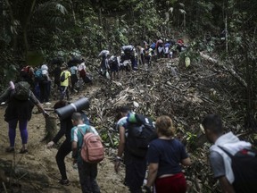 FILE - Migrants walk across the Darien Gap from Colombia to Panama in hopes of reaching the U.S., May 9, 2023.