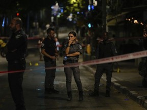 Israeli police inspect the site of a shooting attack in Tel Aviv, Israel, Saturday, Aug 5, 2023. Israeli authorities say a Palestinian gunman opened fire in central Tel Aviv, critically wounding one person before he was shot dead by police.