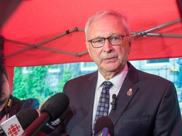 New Brunswick Premier Blaine Higgs speaks to media outside Government House.